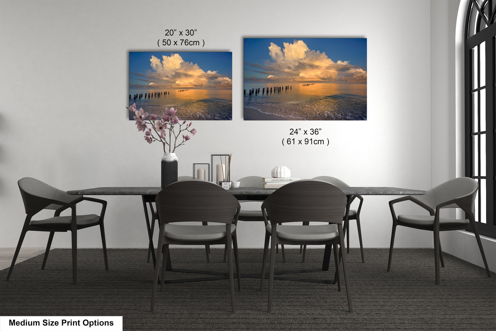 a dining room table with four chairs and a vase of flowers