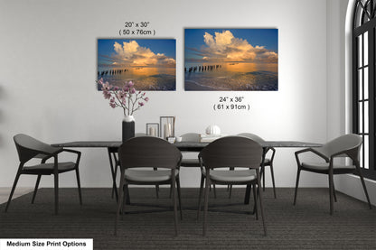 a dining room table with four chairs and a vase of flowers