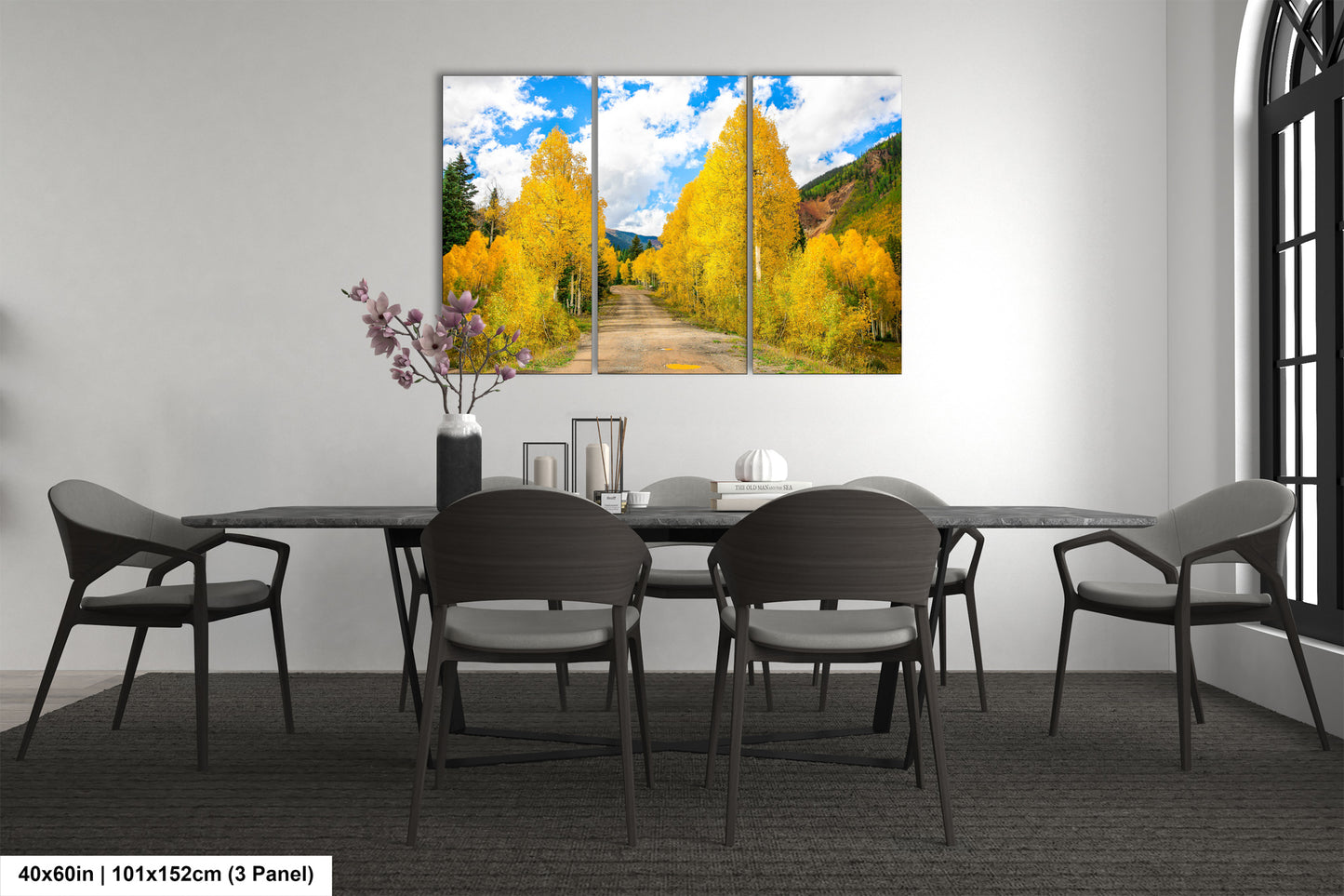a dining room table with four chairs and a painting on the wall