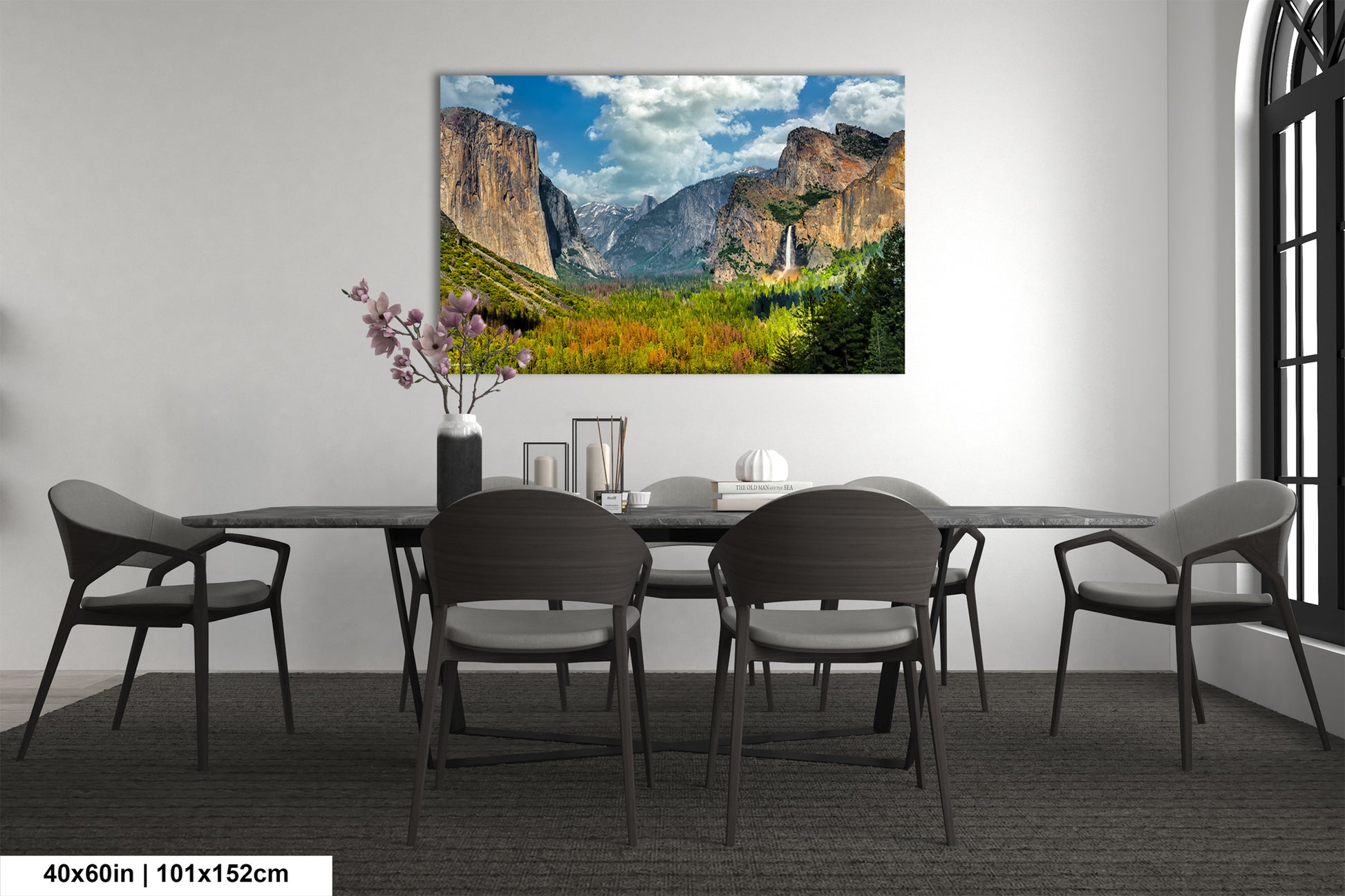 a dining room table with chairs and a painting on the wall