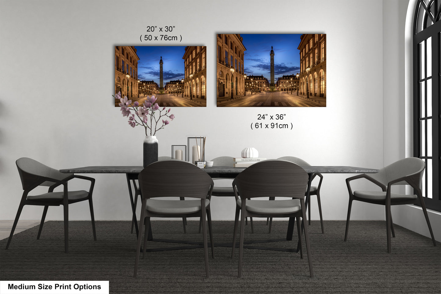 a dining table with four chairs and a vase of flowers