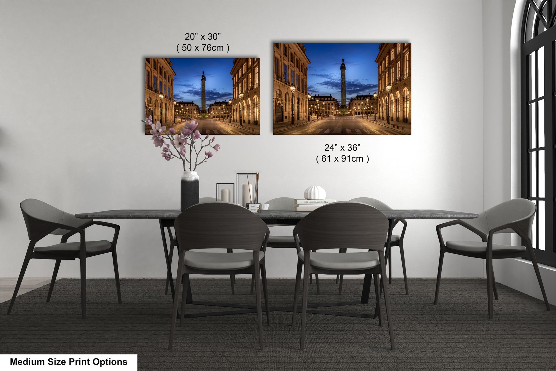 a dining table with four chairs and a vase of flowers