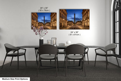 a dining table with four chairs and a vase of flowers