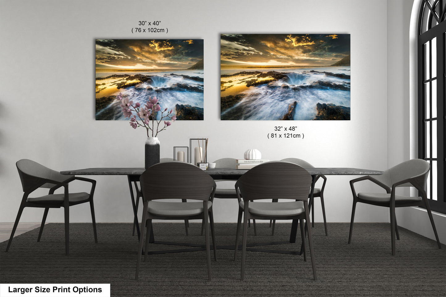 a dining room table with four chairs and two pictures on the wall