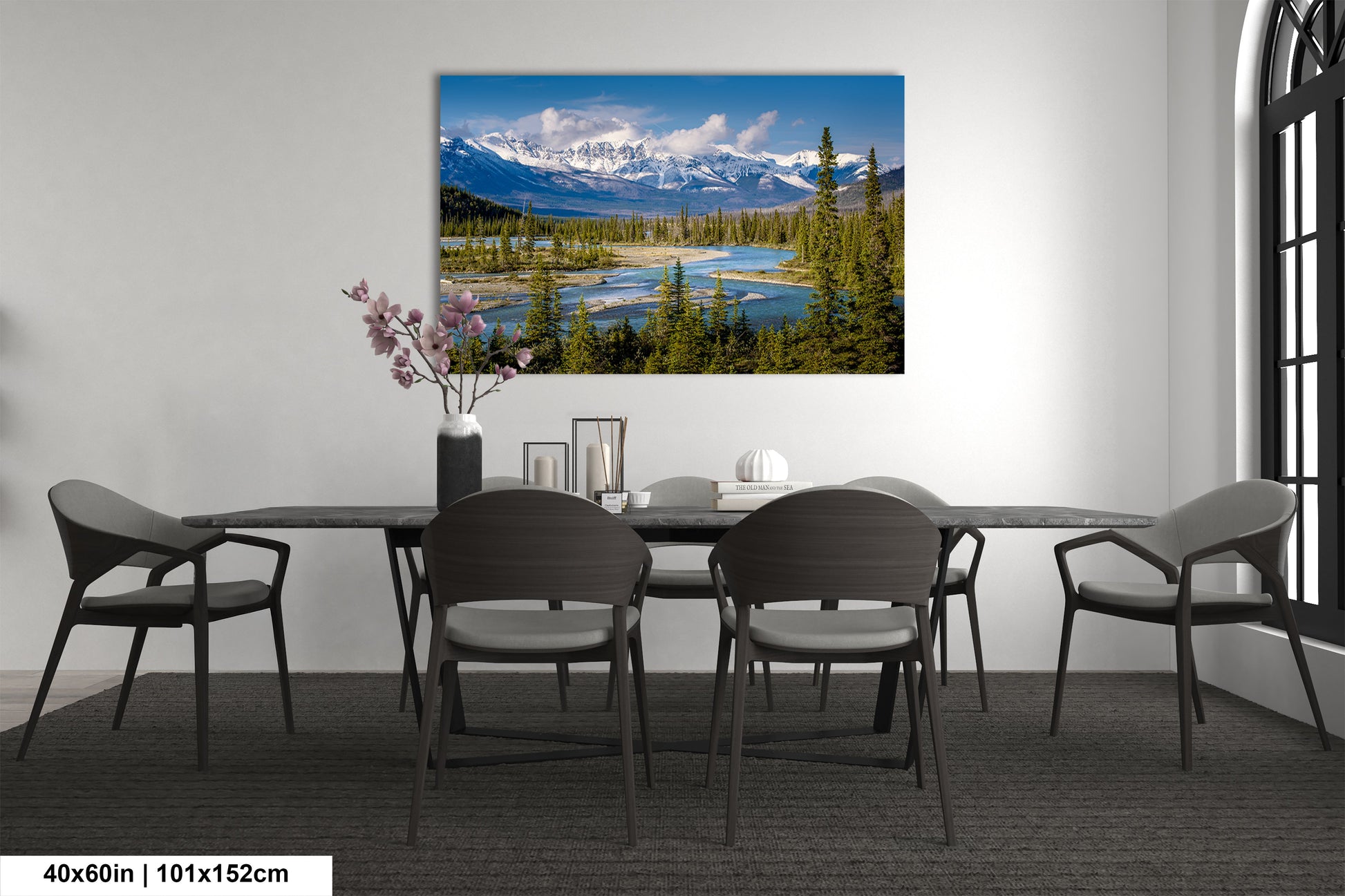 a dining room table with chairs and a painting on the wall