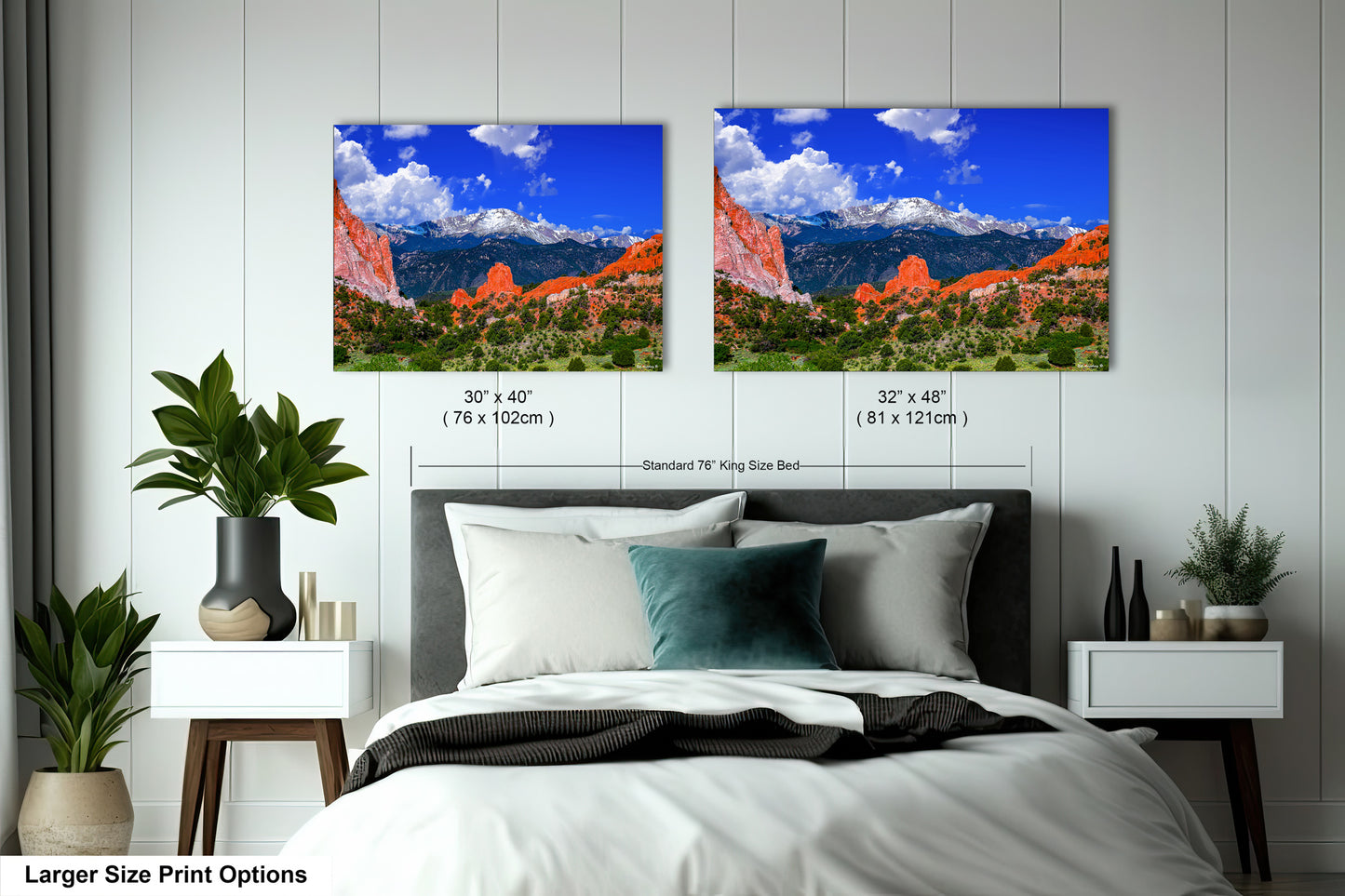 a bed with two pictures of mountains in the background