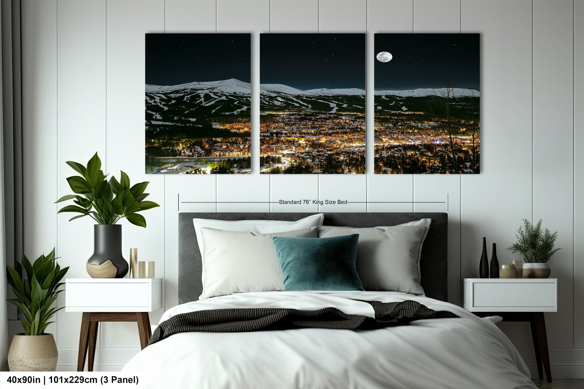 a bedroom with a large bed and three pictures on the wall