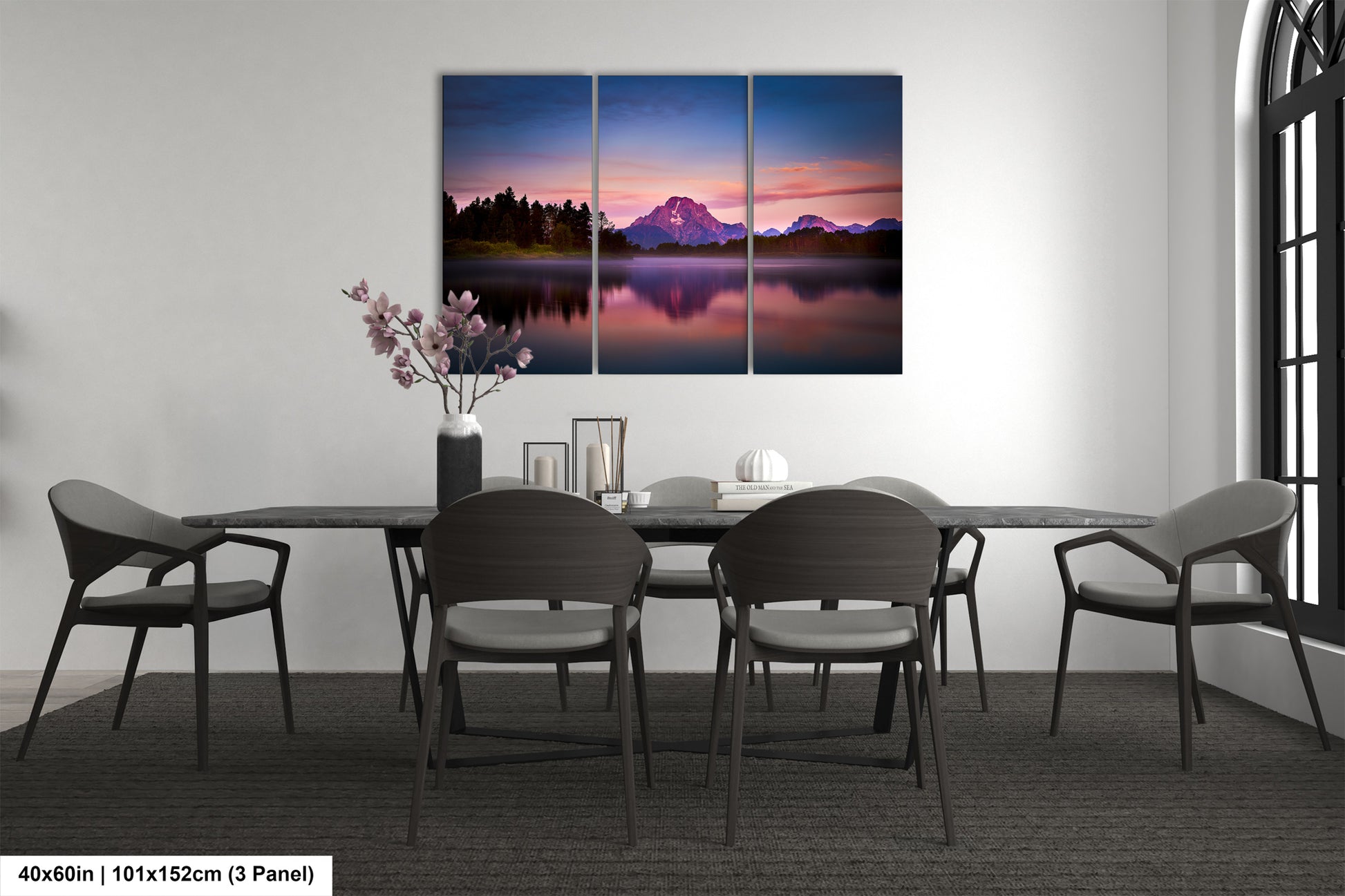 a dining room table with chairs and a painting on the wall