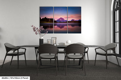 a dining room table with chairs and a painting on the wall