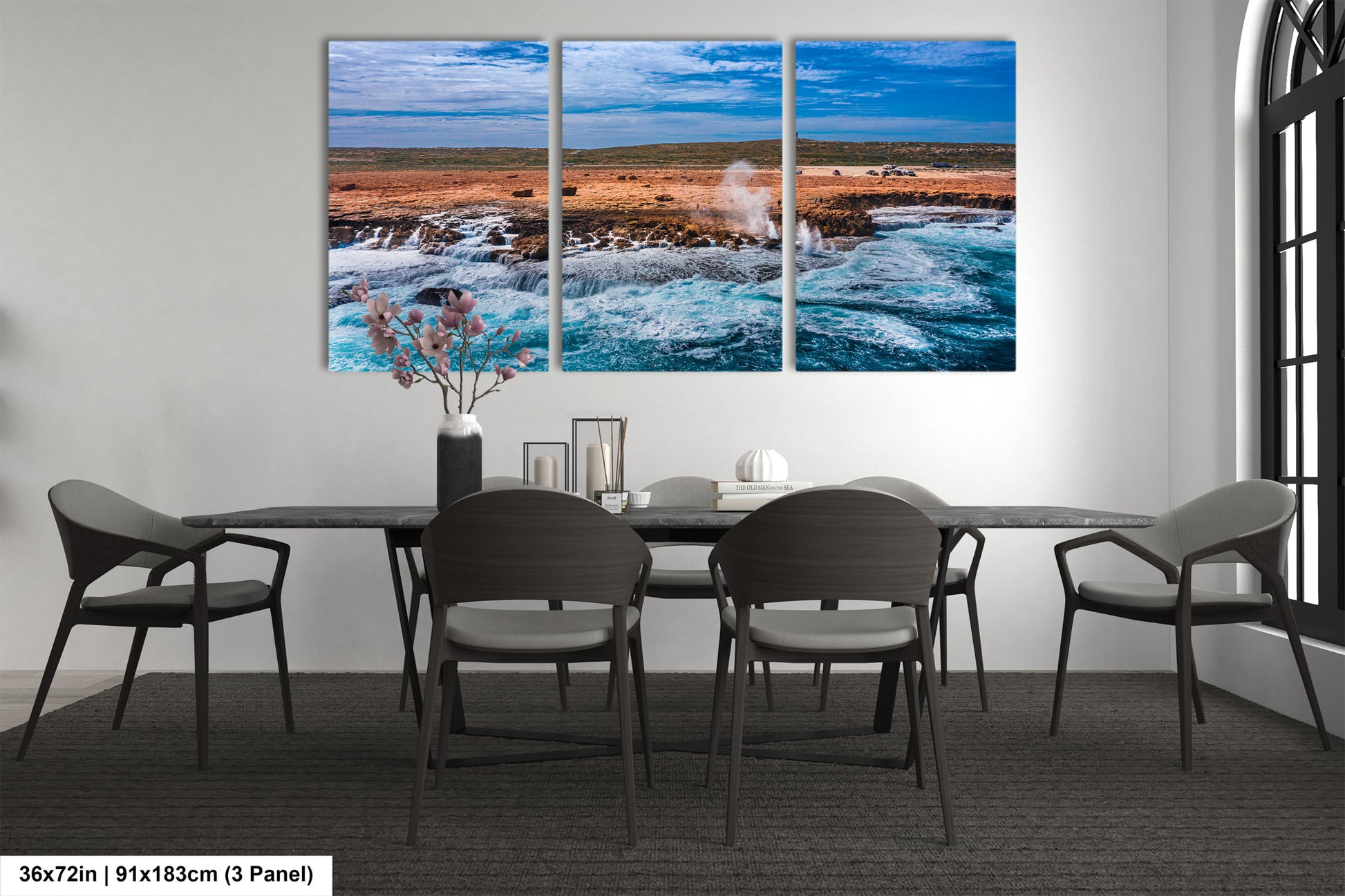 a dining room table with four chairs and a painting on the wall