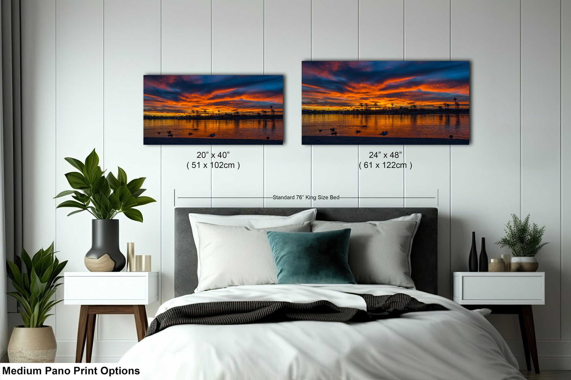 a bedroom with a bed, nightstands, and a large painting of a sunset over a body of water. The painting is framed and hangs on the wall above the bed.