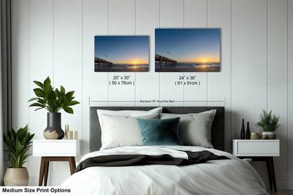 a bedroom with a bed and two pictures on the wall