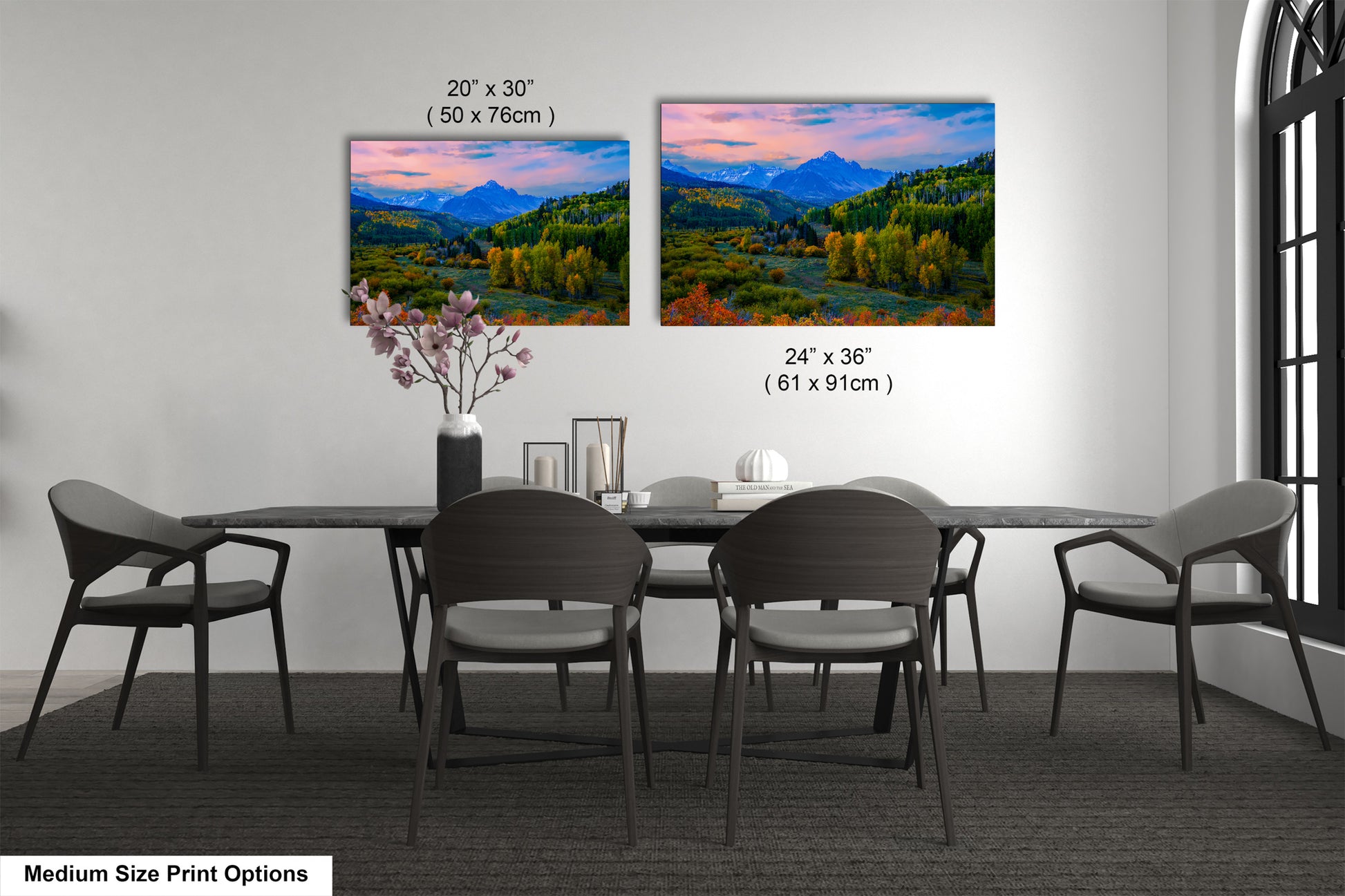 a dining table with four chairs and a vase with flowers