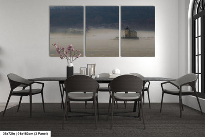a dining room table with four chairs and a vase of flowers