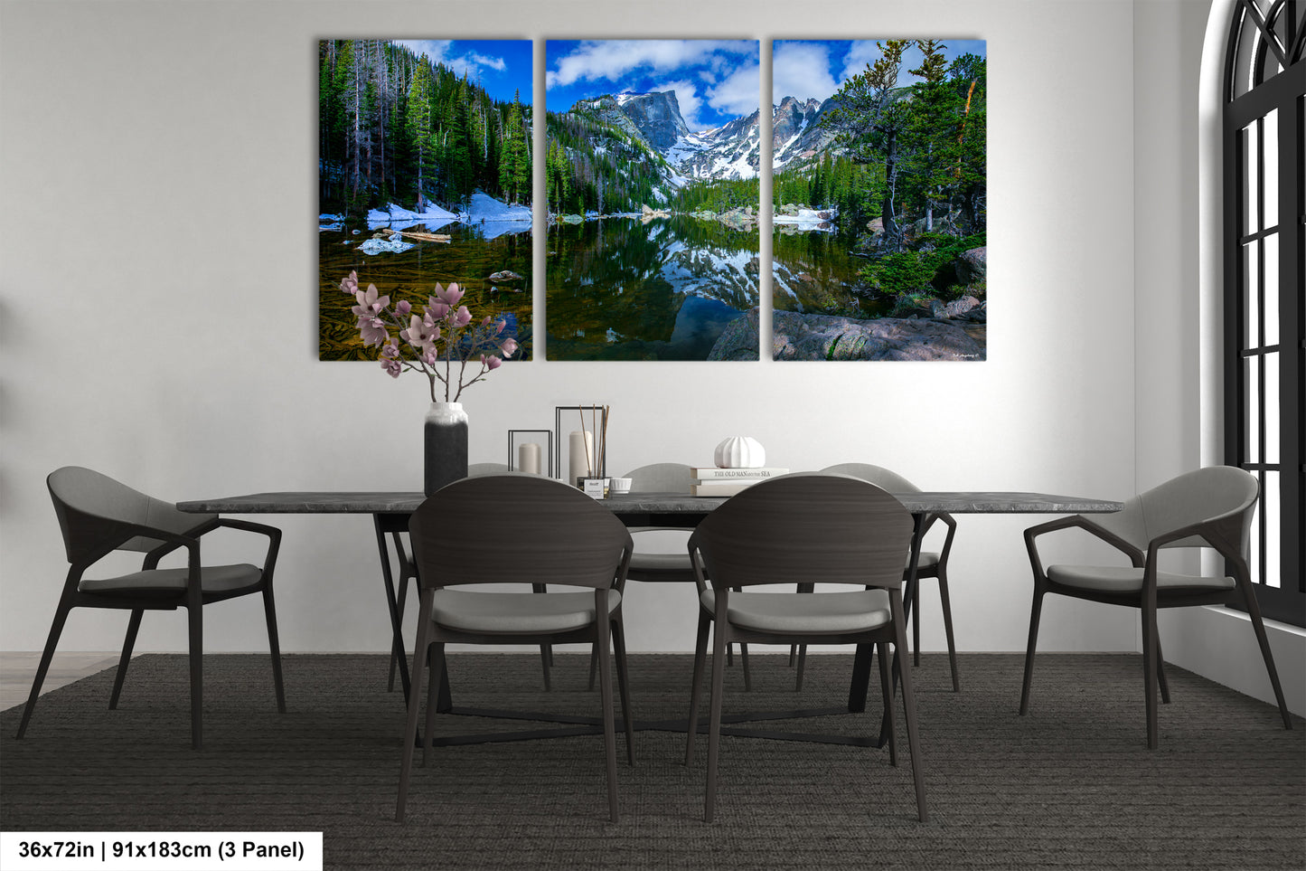a dining room table with four chairs and a painting on the wall