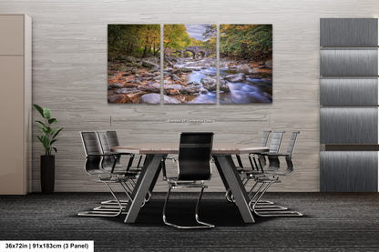a dining room table with chairs and a painting on the wall