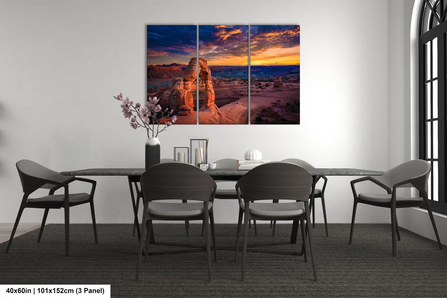 a dining room table with chairs and a painting on the wall