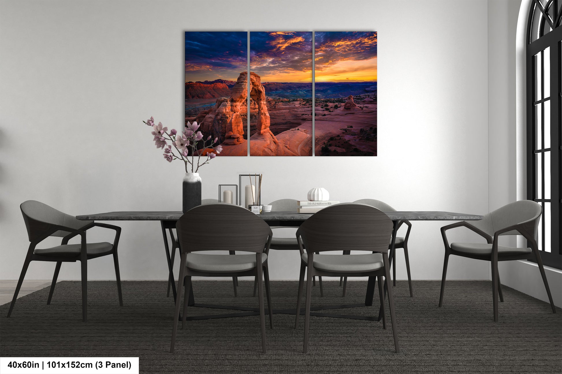 a dining room table with chairs and a painting on the wall