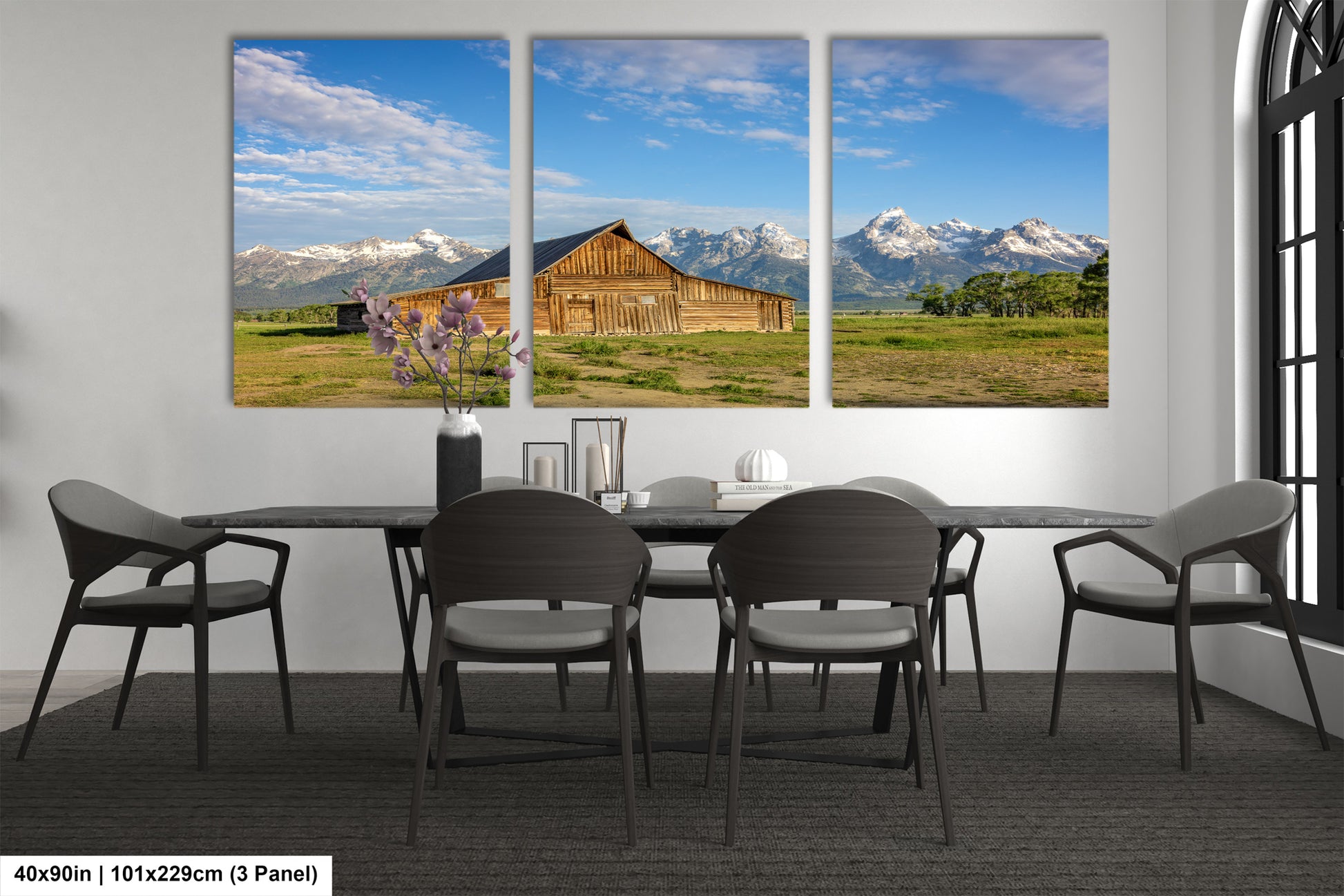 a dining room table with four chairs and three pictures on the wall