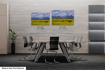 a dining room table with chairs in front of two pictures of mountains