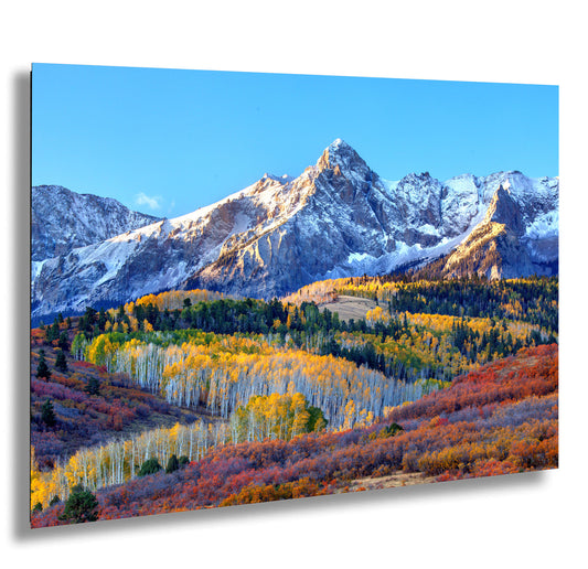 a scenic view of a mountain range in autumn