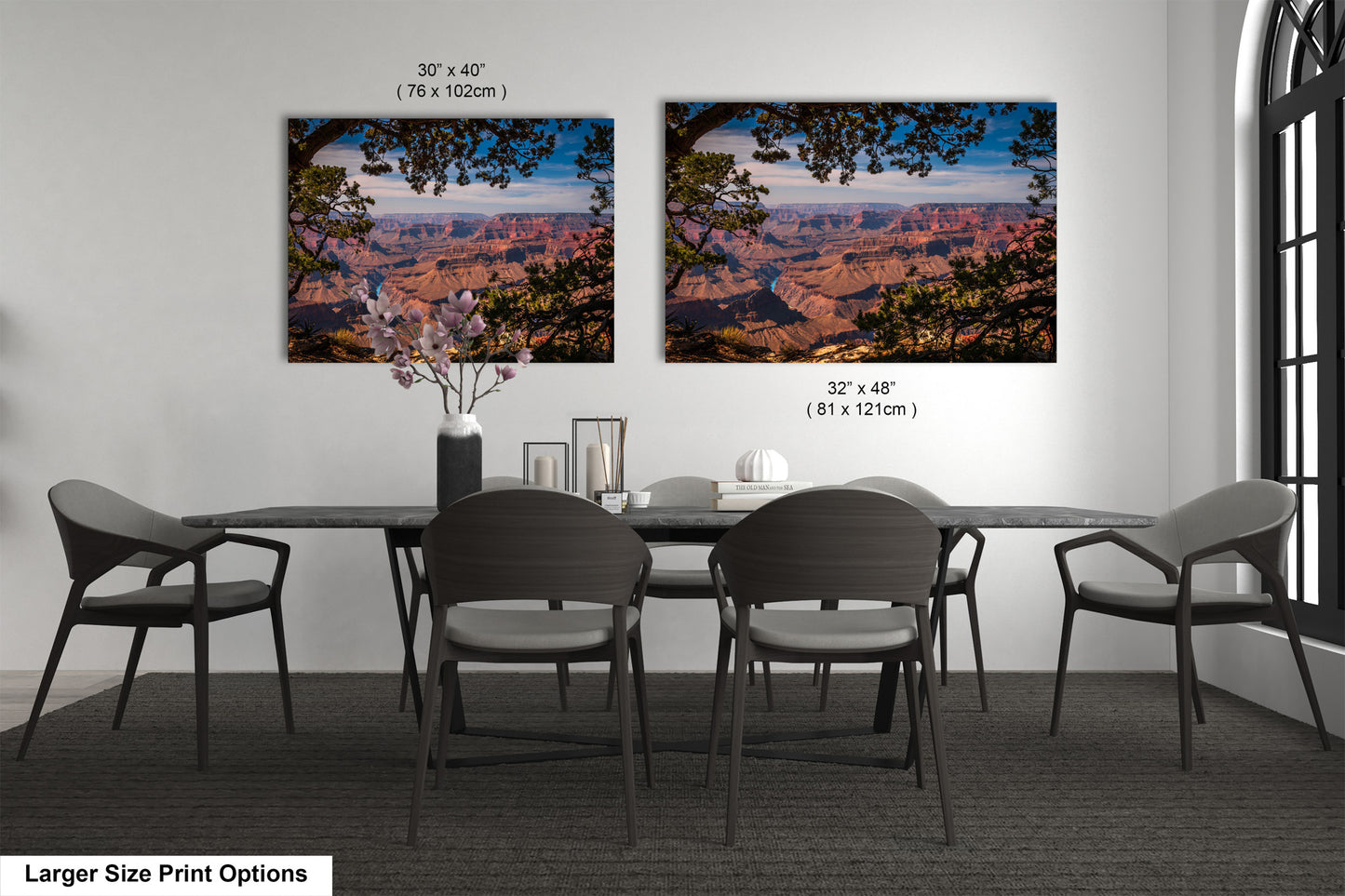 a dining room table with four chairs and a vase of flowers