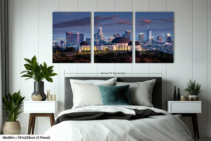 a bedroom with a large bed and two pictures on the wall
