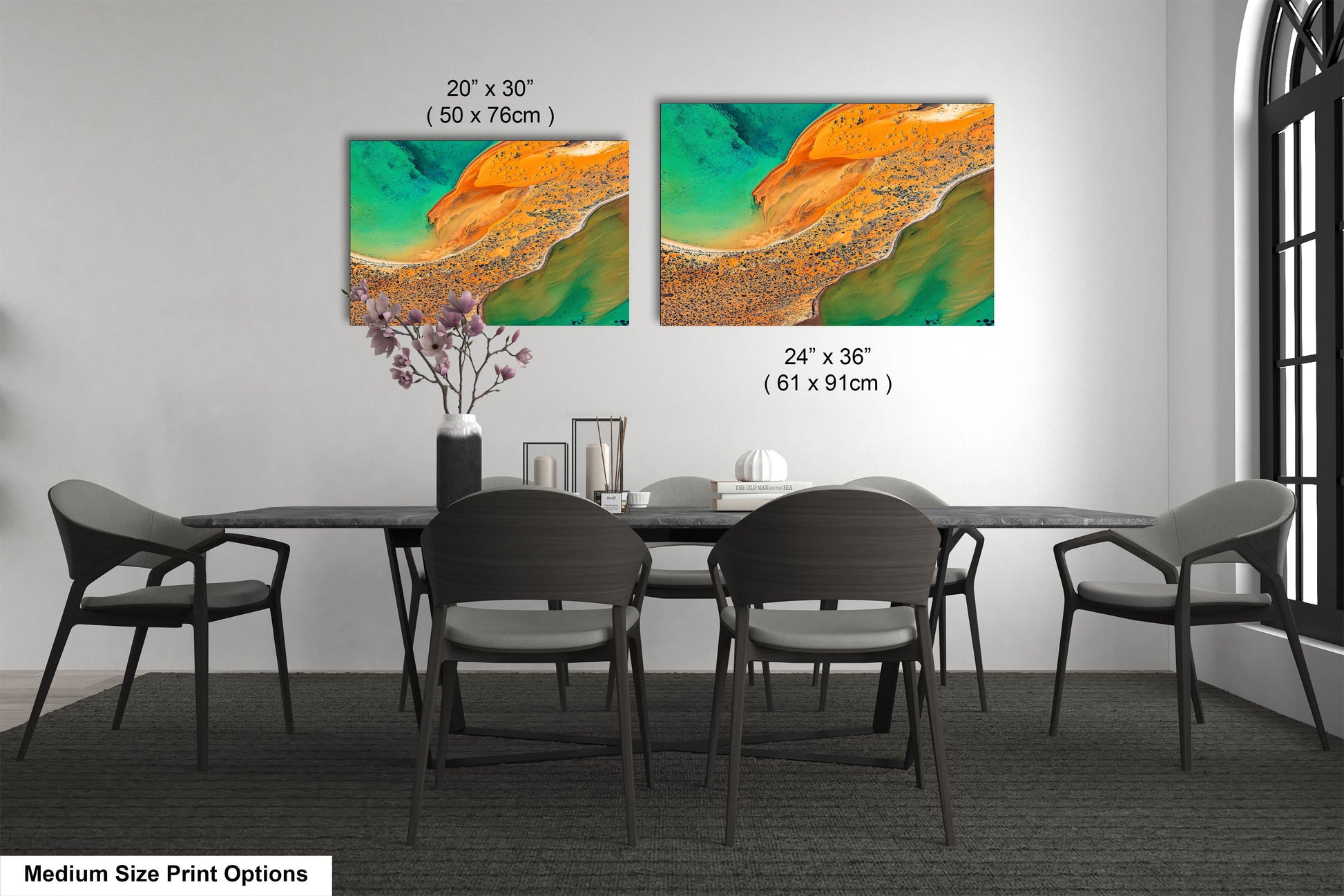 a dining room table with four chairs and a painting on the wall