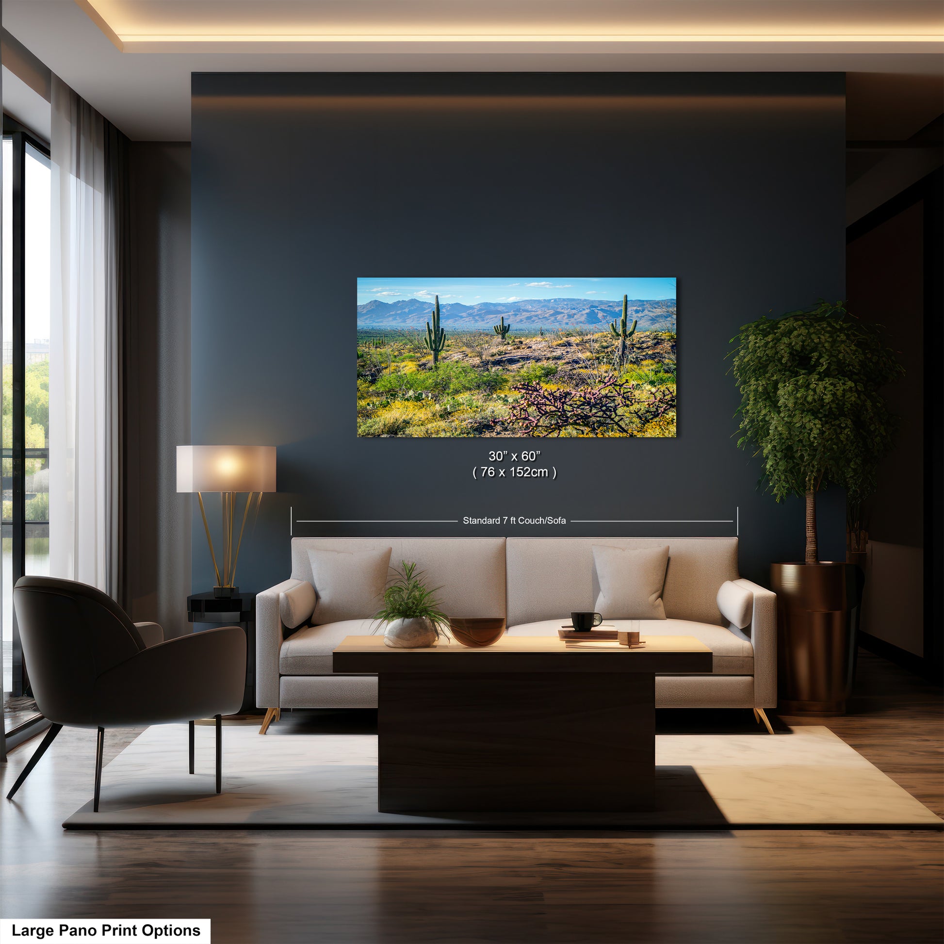 A modern living room with a large framed landscape painting depicting a desert scene hanging on the wall. The painting is approximately 30 inches wide and 7.5 inches tall. The room features a white sofa, a wooden coffee table, and a potted plant, creating a cozy and stylish atmosphere.
