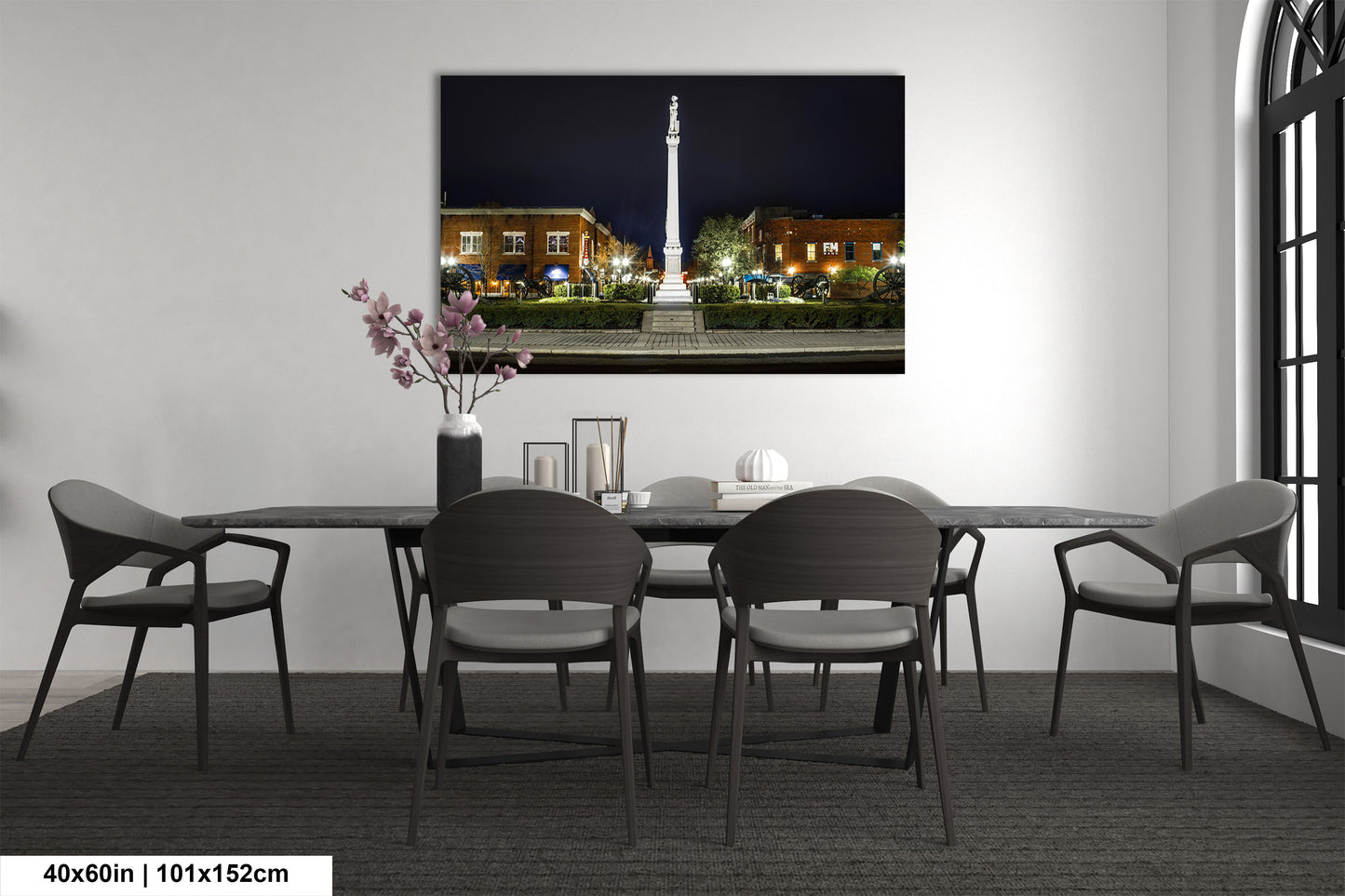 a room with a table and chairs and a picture on the wall