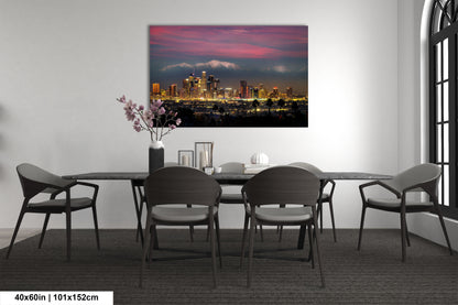 a dining room table with chairs and a painting on the wall