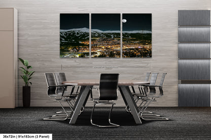 a dining room table with a view of a city at night