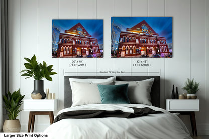 a bed with two pictures on the wall above it