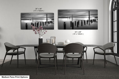 a dining room table with chairs and a vase of flowers