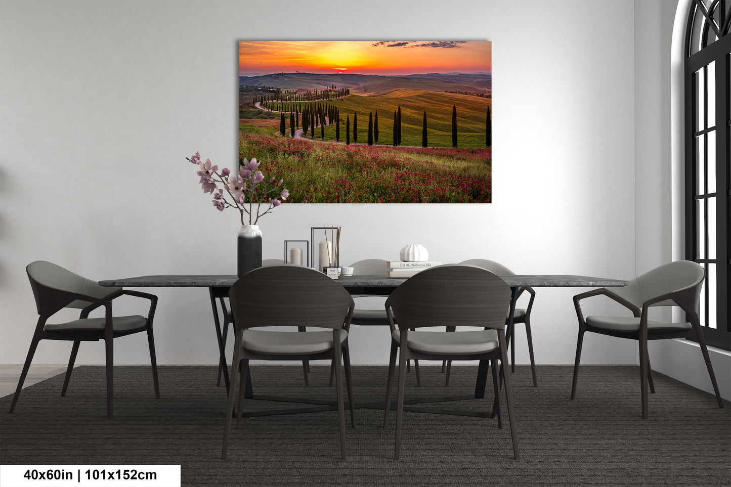 a dining room table with chairs and a painting on the wall