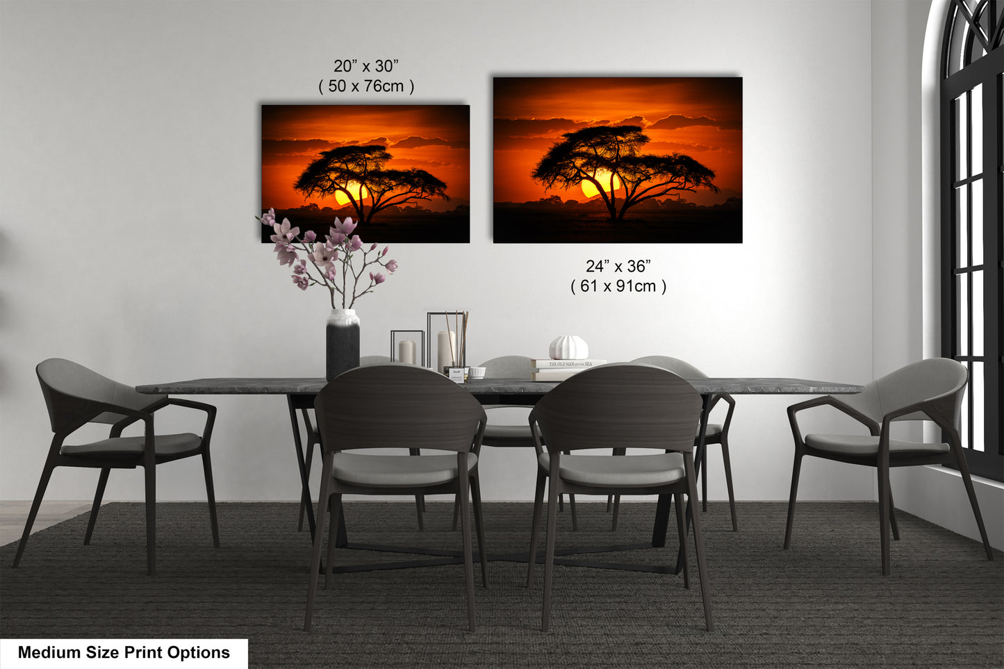 a dining table with four chairs and a vase of flowers