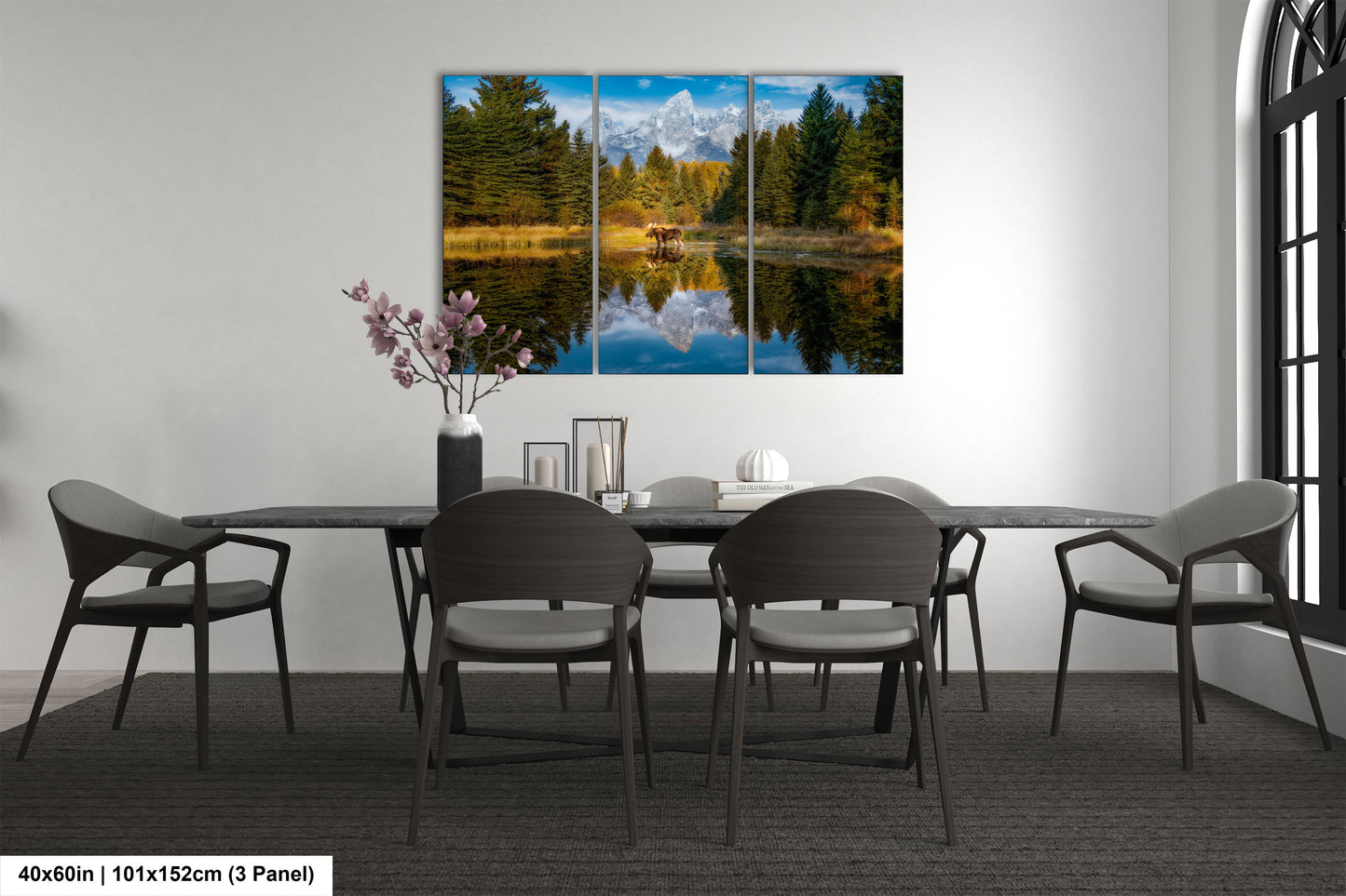 a dining room table with four chairs and a painting on the wall