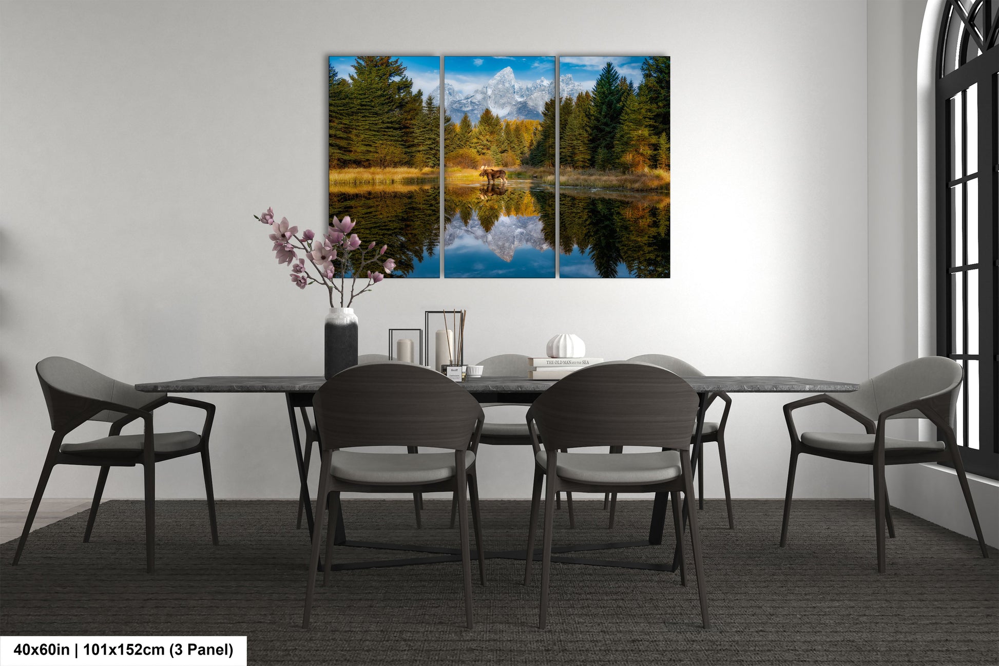 a dining room table with four chairs and a painting on the wall