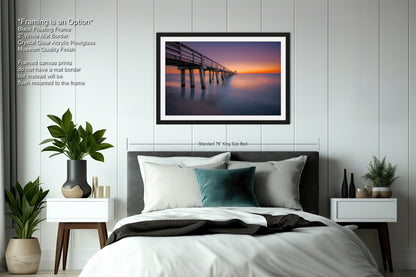 a bedroom with a bed and a picture hanging on the wall