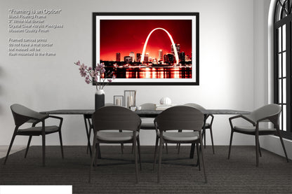 a dining room table with chairs and a picture of the st louis arch