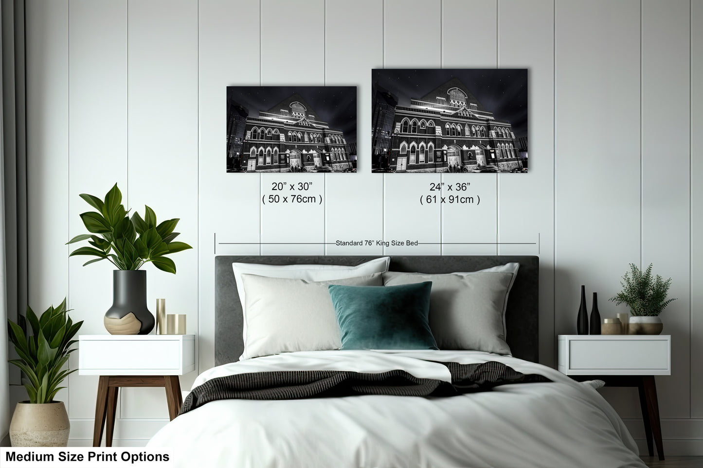 a bed with a white comforter and two black and white pictures on the wall