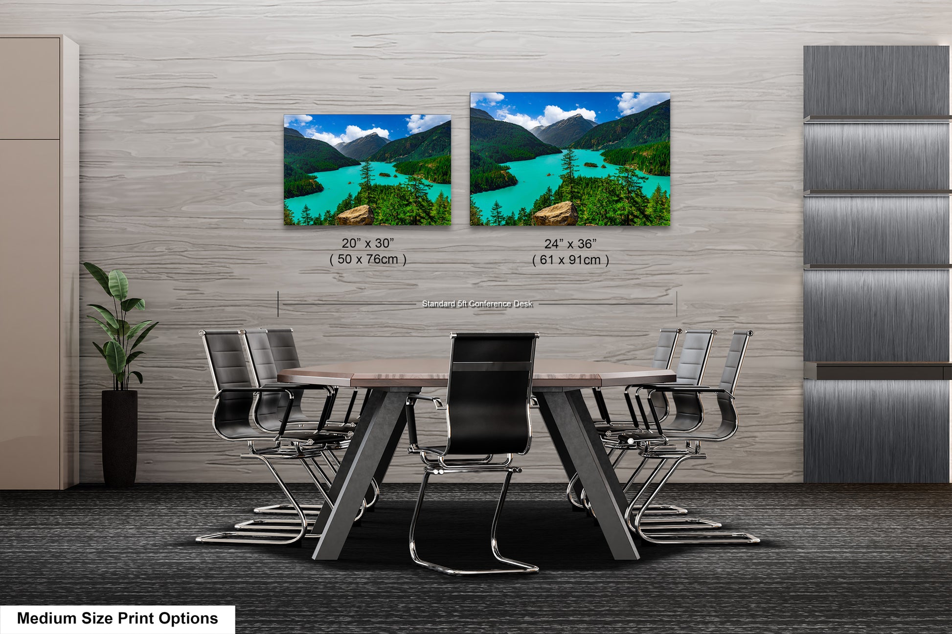 a modern office space with a large wooden table surrounded by black chairs. Above the table, there are two framed landscape photographs depicting a scenic mountain view with turquoise water. The photographs are labeled with their respective sizes, including 20 x 30" and 24 x 36" (61 x 91 mm) dimensions.