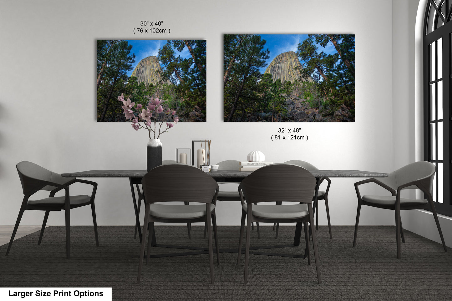 a dining table with four chairs and a vase of flowers