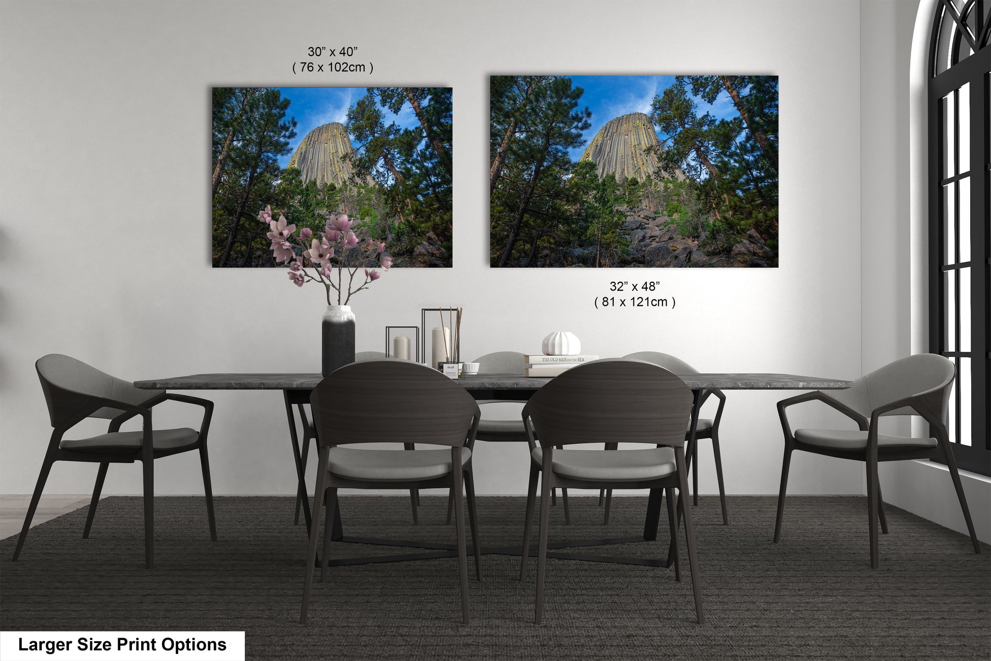 a dining table with four chairs and a vase of flowers