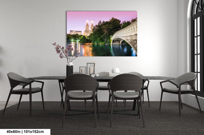 a dining room table with chairs and a painting on the wall