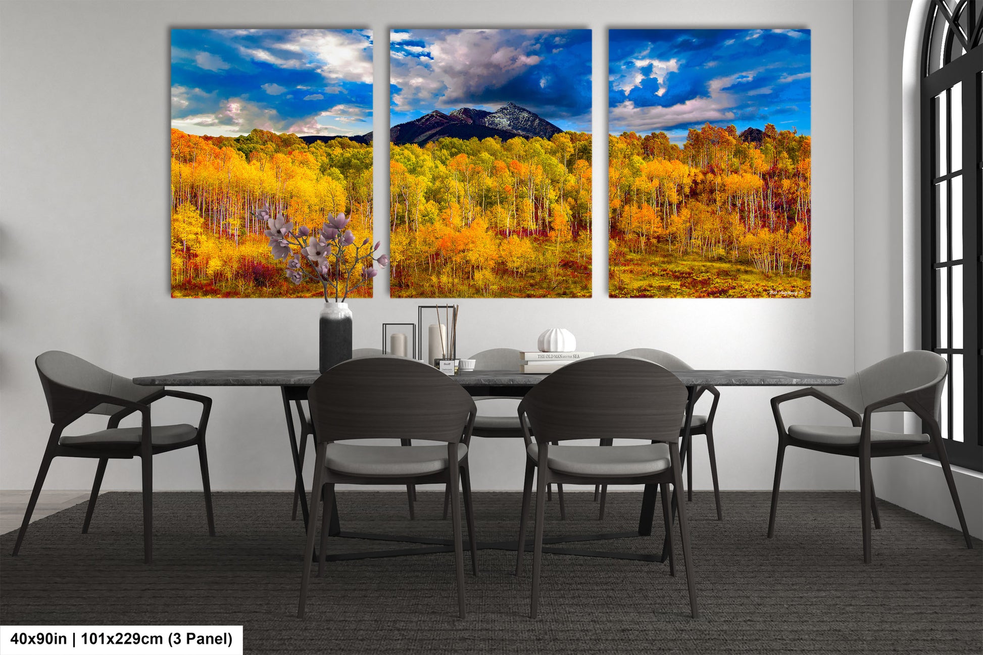 a dining room table with four chairs and a painting on the wall