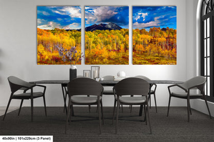 a dining room table with four chairs and a painting on the wall
