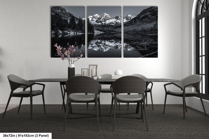a black and white photo of a dining room table