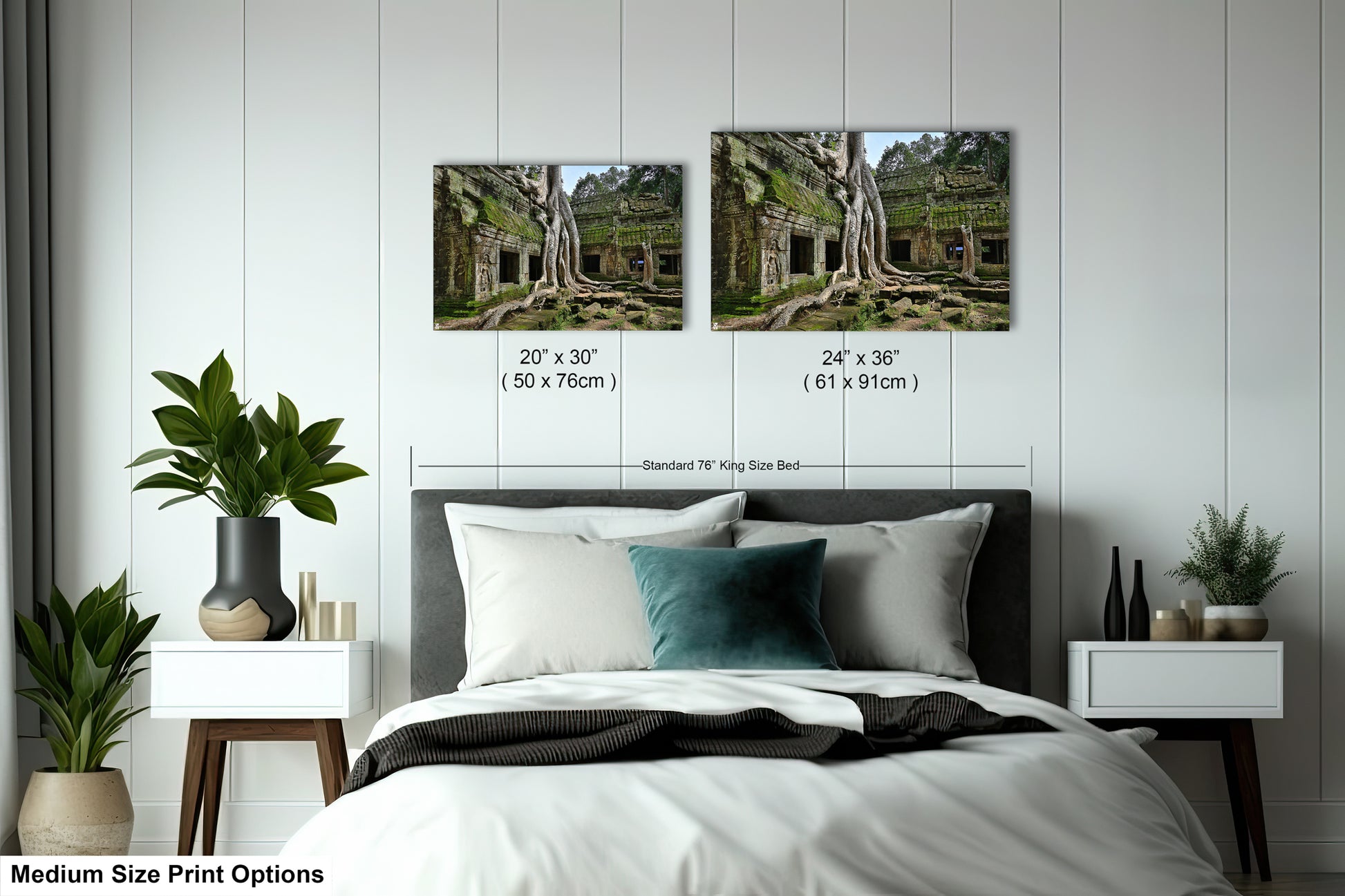 a bed with a white comforter and two pictures on the wall