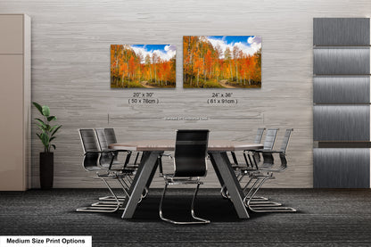 a dining room table with chairs next to a wall with a picture of a forest